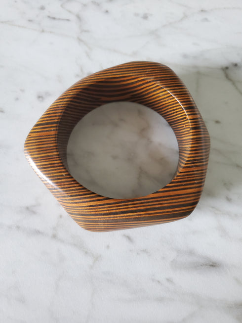 Wooden ring with a marble center on a marble surface