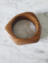 Wooden ring with a marble center on a marble surface