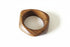 Wooden ring with a marble center on a marble surface