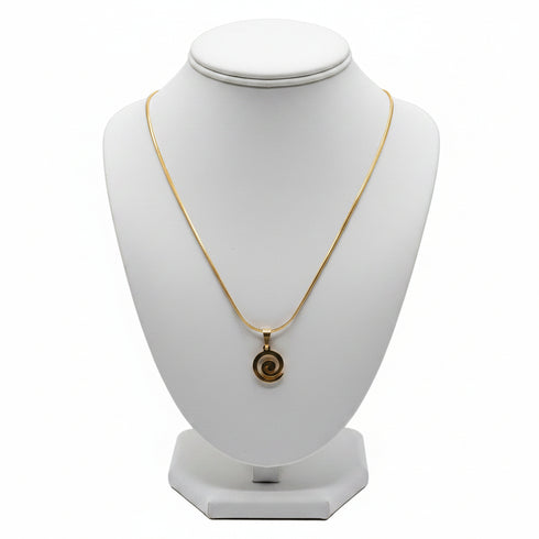 Gold necklace on a marble surface