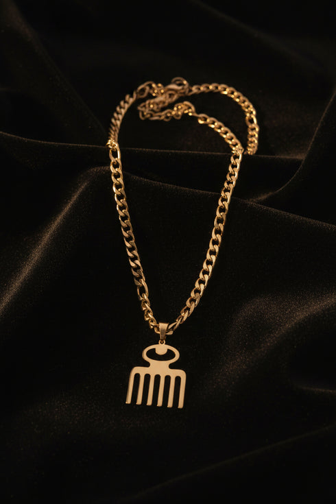 Gold chain with a decorative clasp on a marble surface