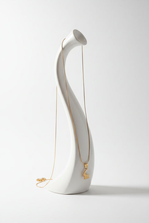 Gold necklace on a marble surface