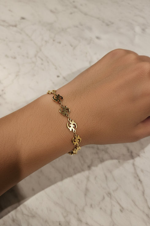 Gold bracelet on a marble surface