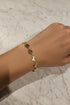 Gold bracelet on a marble surface