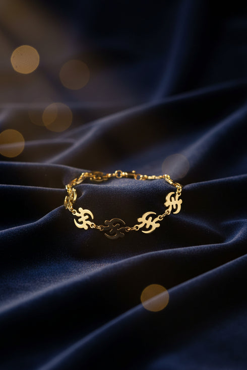 Gold chain bracelet on a marble surface