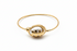 Gold bracelet with a unique design on a white background