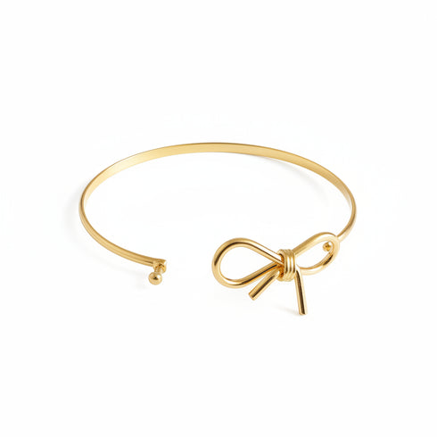Gold bracelet on a marble surface