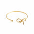 Gold bracelet on a marble surface