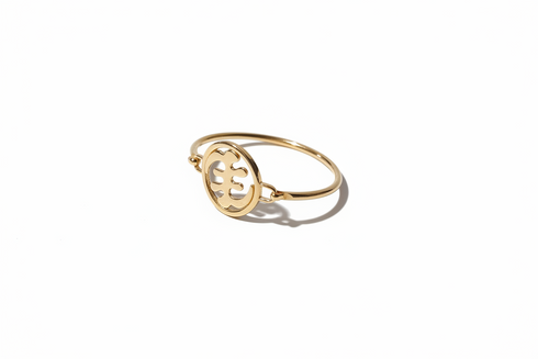 Gold ring with a circular design on a white background