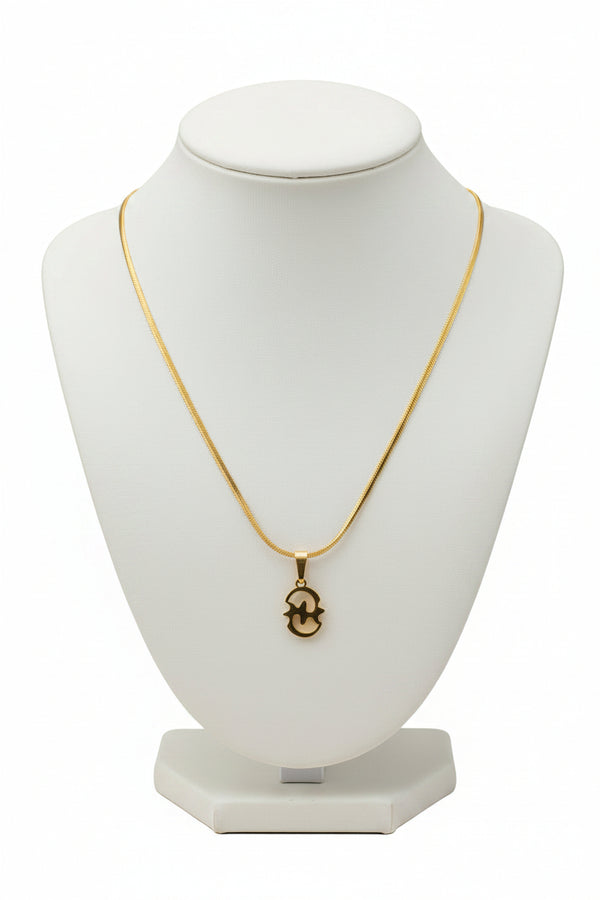 Gold necklace with a decorative clasp on a marble surface