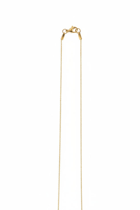 Gold chain on a marble surface