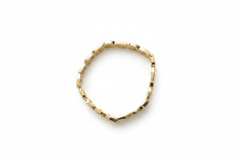Gold bracelet on a marble surface