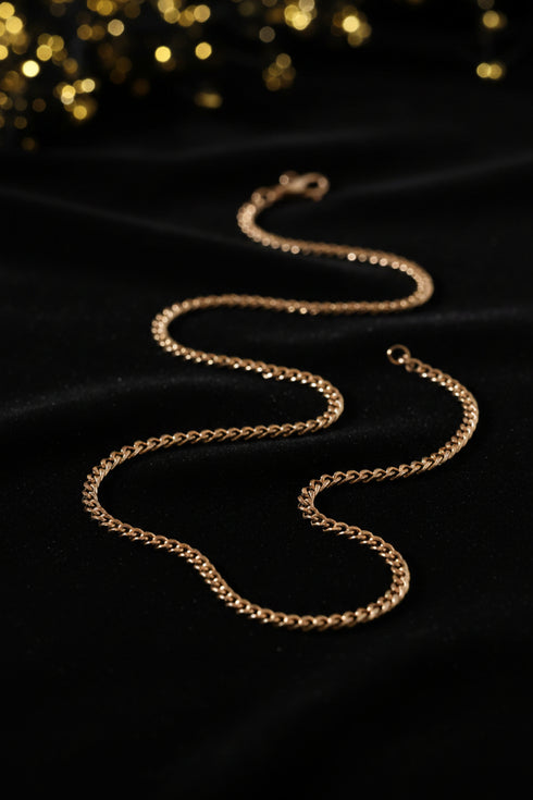 Gold chain on a marble surface