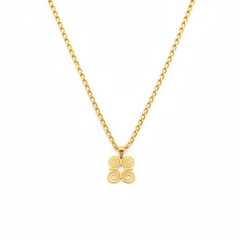 Gold necklace with a spiral pendant on a marble background