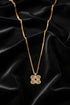 Gold chain necklace with decorative clasp on a marble surface