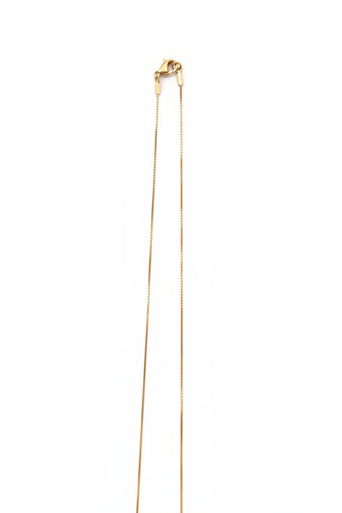 Gold necklace on a marble surface