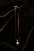 Gold necklace on a marble surface