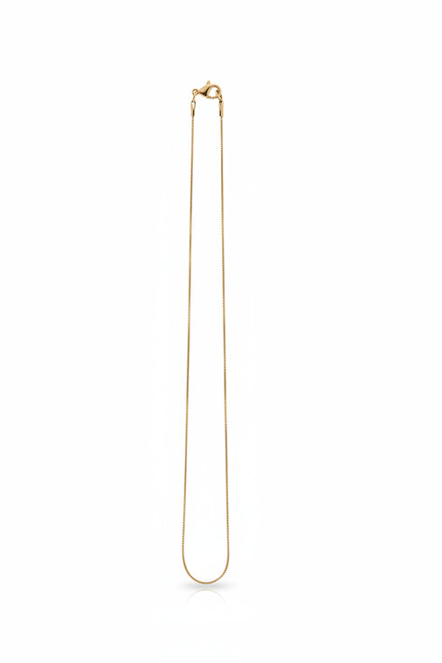 Gold necklace on a marble surface