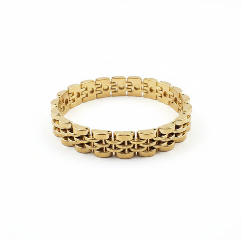 Gold bracelet on a marble surface