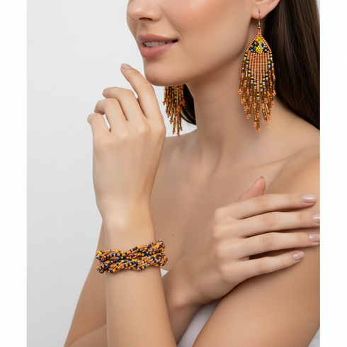 Woman wearing orange beaded earrings and bracelet on a white background