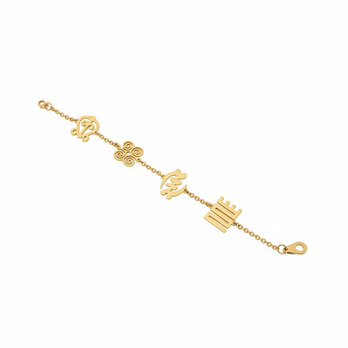 Gold bracelet with various charms on a marble surface
