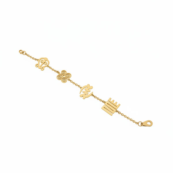 Gold bracelet with various charms on a marble surface