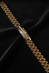 Gold bracelet with diamond accents on a black satin background