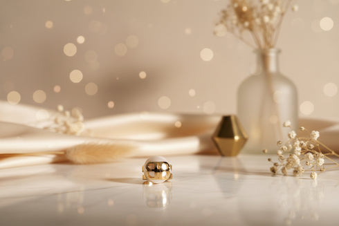 Gold and white ring on a marble surface