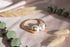 Gold bracelet with white pearls on a marble background