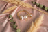 Gold and pearl earring on a marble surface