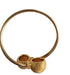 Gold bracelet with textured design on a marble surface