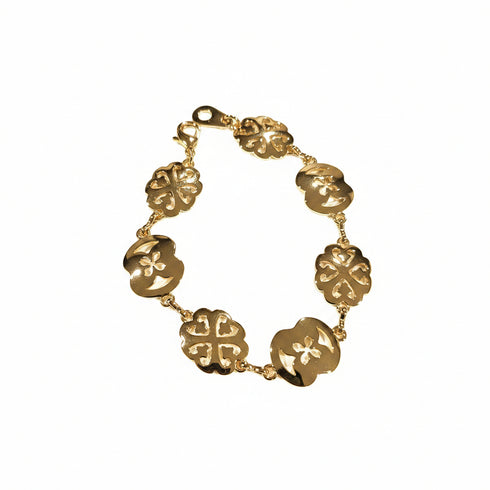 Gold bracelet on a marble surface