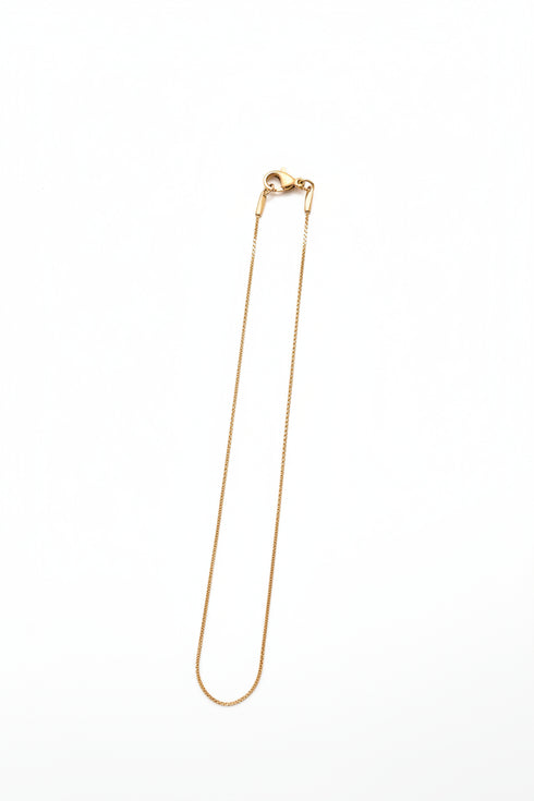 Gold Necklace on a marble surface