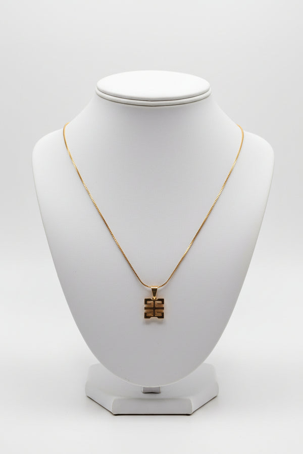 Gold necklace on a marble surface