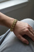 Gold bracelet on a marble surface