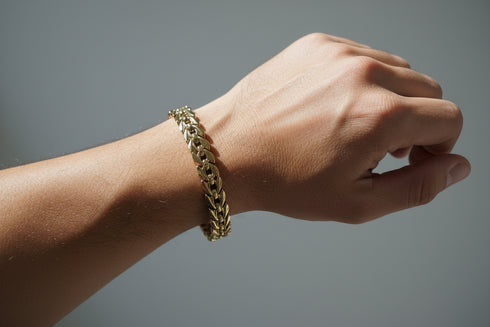 Gold chain bracelet on a marble surface