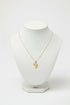 Gold necklace with a African map pendant on a marble surface