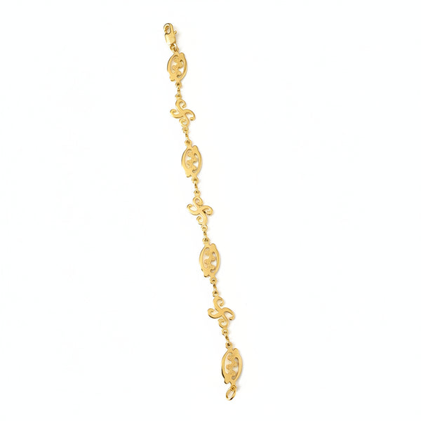 Gold bracelet with intricate designs on a white background