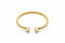 Gold bracelet with diamond accents on a marble surface