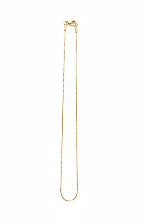 Gold necklace on a marble surface