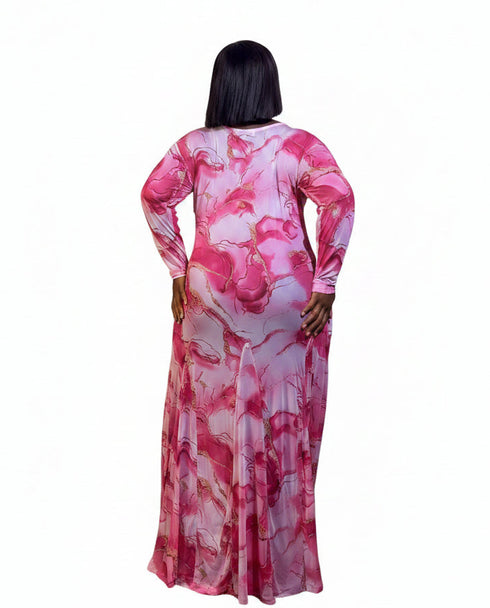 A woman viewed from the back wearing a long-sleeve maxi dress with a pink and white marble pattern, set against a plain white background.