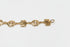 Gold bracelet with engraved symbols on a marble surface