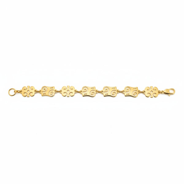 Gold bracelet with floral links on a white background
