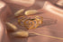Gold bracelet on a soft fabric background with dried grasses
