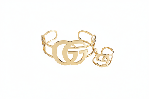 Gold bracelet and ring set on a white background