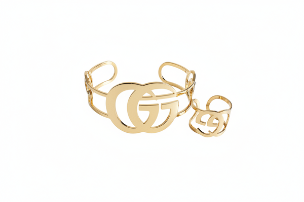 Gold bracelet and ring set on a white background
