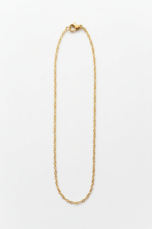 Gold necklace on a marble surface