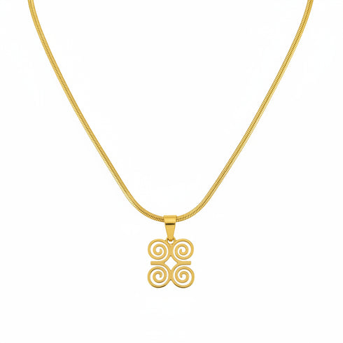 Gold hairpin with decorative end on a marble surface