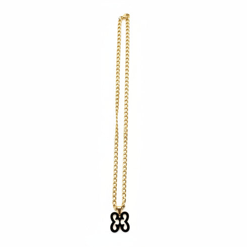 Gold chain with a decorative clasp on a marble surface
