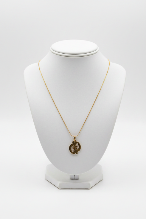 Gold necklace on a white mannequin bust against a white background
